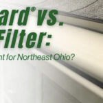 Close-up of a house roof and gutter with text: K-Guard vs LeafFilter: Which Is Right for Northeast Ohio? The K-Guard logo appears in the lower left corner, emphasizing the comparison between these two popular gutter protection systems.