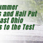 Text on image reads: How Summer Storms and Hail Put Northeast Ohio Gutters to the Test. Rain falls heavily on a metal surface, highlighting the risk of storm damage gutters face each season in Northeast Ohio. K Guard Leaf Free Gutter System logo appears in the bottom left corner.